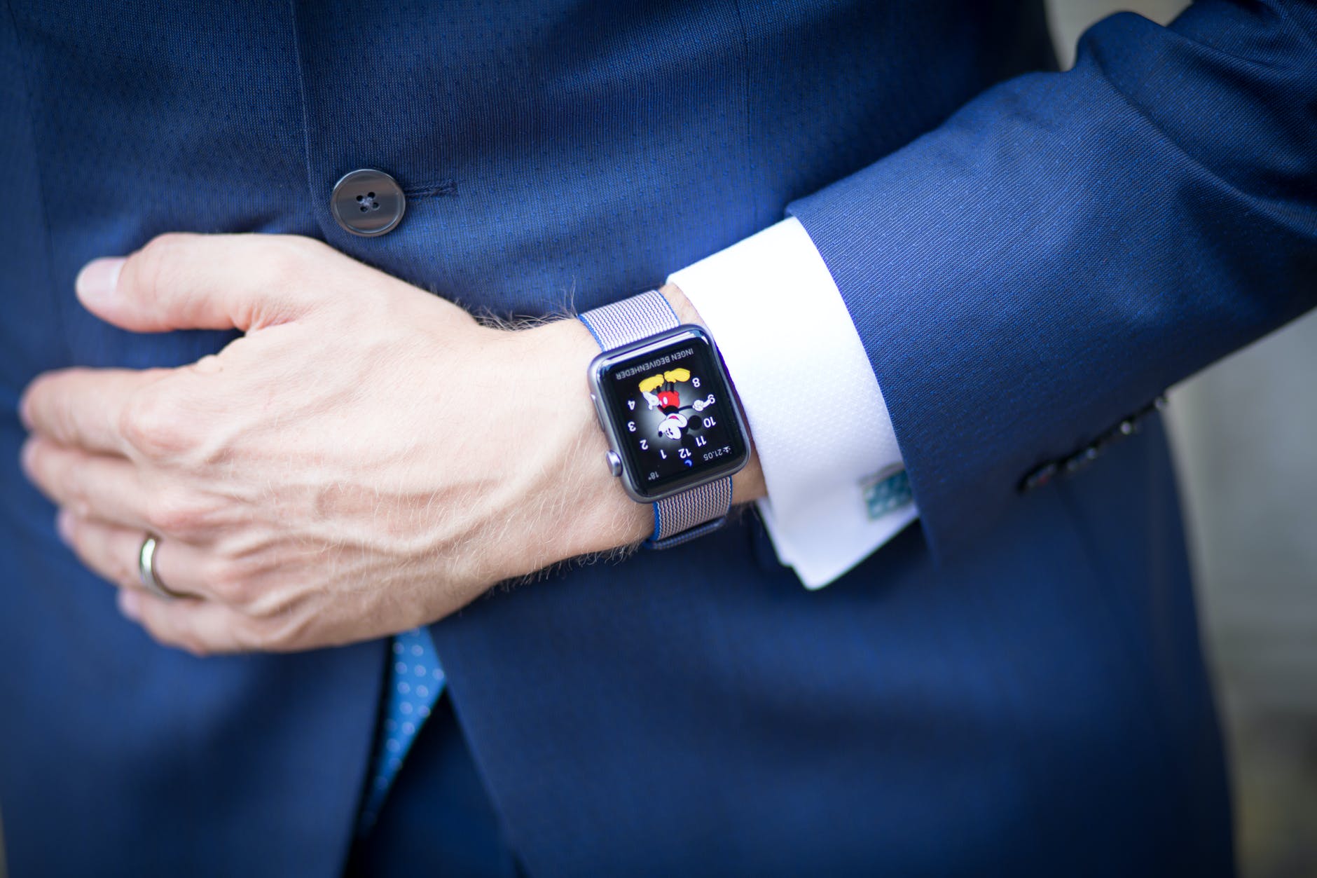 man wearing blue blazer and silver smart watch
